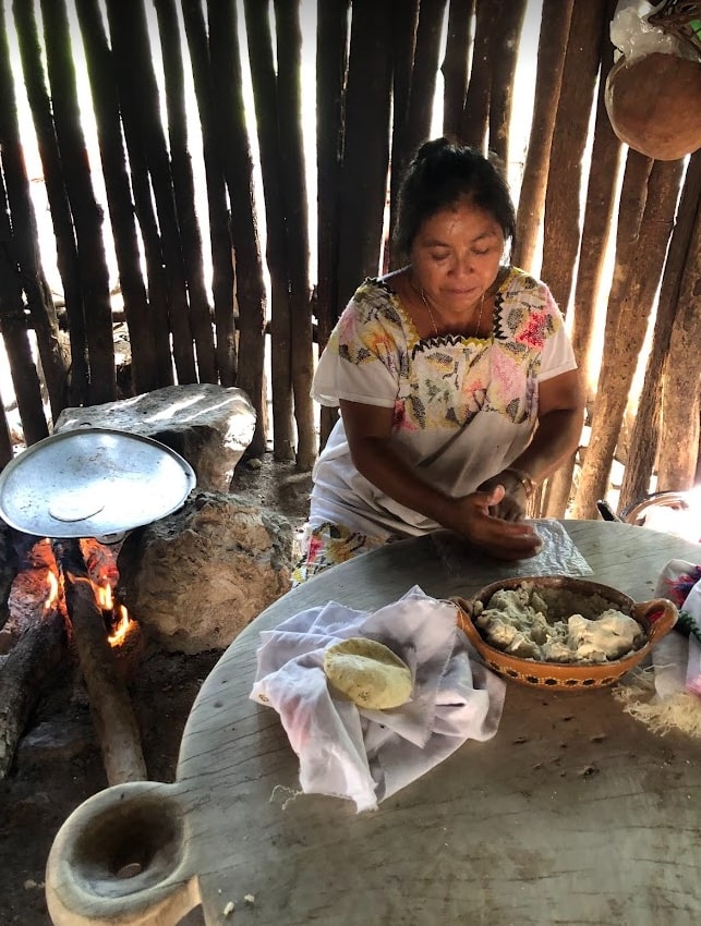 Mayan woman making tortillas. Aldea Maya experience by Tulum Diving Travel